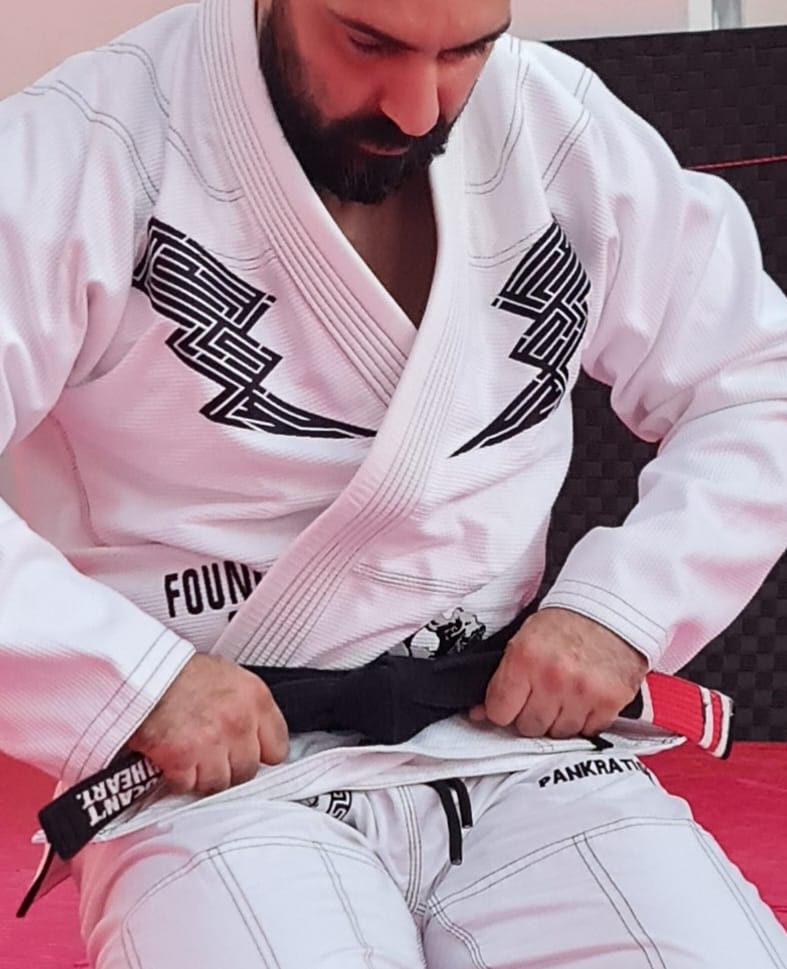 Head instructor John Ioannou tying his black belt